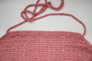 weaving the icord through the front panel of a summer crochet top