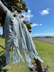 crochet blanket hung on a tree