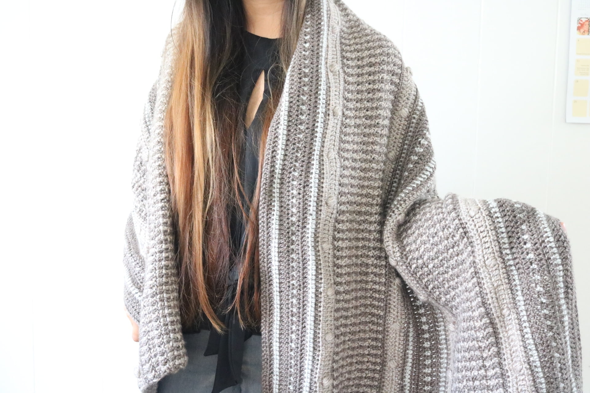 Girl wearing a textured crochet blanket wrap
