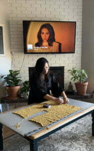 pinning crocheted pieces on a mat getting ready to steam block